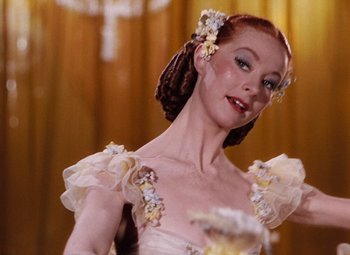 Movie still from “The Tales of Hoffmann” (1951), directed by Michael Powell – A person wearing a dress; Close Up shot, Low angle