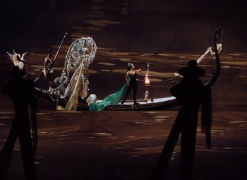 Movie still from “The Tales of Hoffmann” (1951), directed by Michael Powell – A group of people standing on top of a boat in the water; Extreme Wide shot, High angle