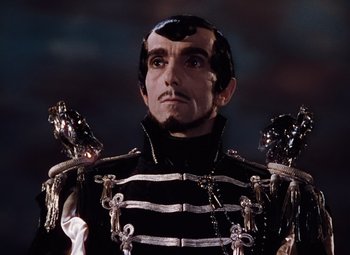 Movie still from “The Tales of Hoffmann” (1951), directed by Michael Powell – A person wearing a costume; Close Up shot, Low angle