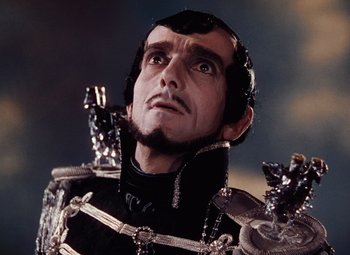 Movie still from “The Tales of Hoffmann” (1951), directed by Michael Powell – A person wearing a costume; Close Up shot, Low angle