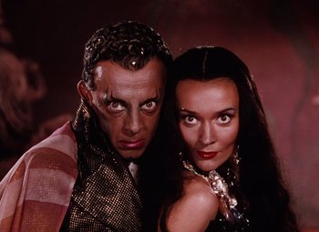 Movie still from “The Tales of Hoffmann” (1951), directed by Michael Powell – A man and a woman posing for a picture; Close Up shot, Low angle