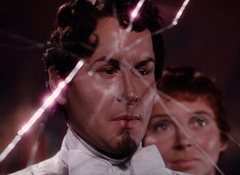 Movie still from “The Tales of Hoffmann” (1951), directed by Michael Powell – A man in a bow tie and a woman in a white dress; Close Up shot, Low angle