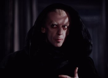 Movie still from “The Tales of Hoffmann” (1951), directed by Michael Powell – A man in a black robe and a black hood; Close Up shot, Over the shoulder angle