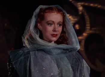 Movie still from “The Tales of Hoffmann” (1951), directed by Michael Powell – A woman with red hair wearing a blue veil; Close Up shot, Low angle