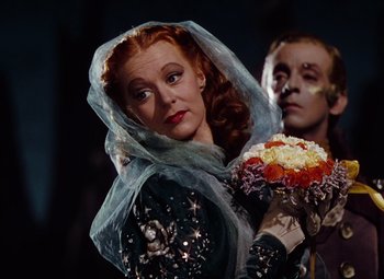 Movie still from “The Tales of Hoffmann” (1951), directed by Michael Powell – A man and a woman dressed up in costumes; Close Up shot, Low angle