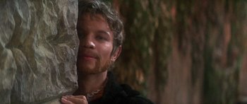 Movie still from “The Taming of The Shrew” (1967), directed by Franco Zeffirelli – A person holding a tree trunk; Close Up shot, Over the shoulder angle