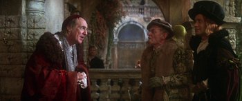 Movie still from “The Taming of The Shrew” (1967), directed by Franco Zeffirelli – Two men in medieval garb talking to each other; Medium shot, Over the shoulder angle