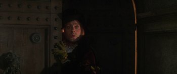 Movie still from “The Taming of The Shrew” (1967), directed by Franco Zeffirelli – A woman in a hat and gloves standing next to a wooden post; Close Up shot, Low angle