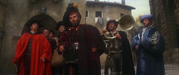 Movie still from “The Taming of The Shrew” (1967), directed by Franco Zeffirelli – A group of people dressed in medieval costumes; Wide shot, Low angle