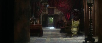 Movie still from “The Taming of The Shrew” (1967), directed by Franco Zeffirelli – A room filled with furniture and red curtains; Extreme Wide shot, High angle