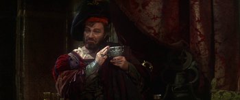 Movie still from “The Taming of The Shrew” (1967), directed by Franco Zeffirelli – A man dressed as a pirate holding a bowl; Medium shot, Over the shoulder angle