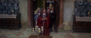 Movie still from “The Taming of The Shrew” (1967), directed by Franco Zeffirelli – A group of people standing in front of a doorway; Wide shot, High angle