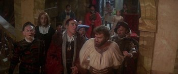 Movie still from “The Taming of The Shrew” (1967), directed by Franco Zeffirelli – A group of people dressed in medieval clothing; Medium shot, Over the shoulder angle