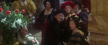 Movie still from “The Taming of The Shrew” (1967), directed by Franco Zeffirelli – A group of people dressed up in costumes; Medium shot, Over the shoulder angle