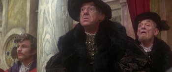 Movie still from “The Taming of The Shrew” (1967), directed by Franco Zeffirelli – An older man wearing a black hat and a fur coat; Close Up shot, Low angle
