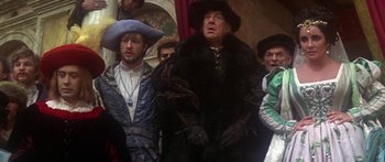 Movie still from “The Taming of The Shrew” (1967), directed by Franco Zeffirelli – A group of people in costumes standing next to each other; Medium shot, Over the shoulder angle
