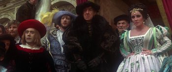 Movie still from “The Taming of The Shrew” (1967), directed by Franco Zeffirelli – A group of men standing next to each other wearing hats; Medium shot, Low angle