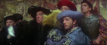 Movie still from “The Taming of The Shrew” (1967), directed by Franco Zeffirelli – A group of men wearing hats and coats; Medium shot, Over the shoulder angle