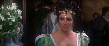 Movie still from “The Taming of The Shrew” (1967), directed by Franco Zeffirelli – A person wearing a costume; Close Up shot, Over the shoulder angle