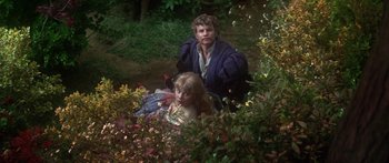 Movie still from “The Taming of The Shrew” (1967), directed by Franco Zeffirelli – A man and a woman sitting in a garden; Medium shot, High angle
