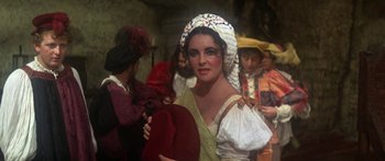 Movie still from “The Taming of The Shrew” (1967), directed by Franco Zeffirelli – A woman wearing a hat in a crowd; Medium shot, High angle