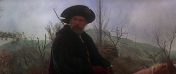 Movie still from “The Taming of The Shrew” (1967), directed by Franco Zeffirelli – An old man in a black hat and a beard; Medium shot, Over the shoulder angle