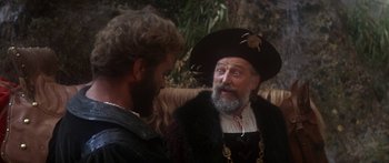 Movie still from “The Taming of The Shrew” (1967), directed by Franco Zeffirelli – A man wearing a pirate hat talking to another man; Close Up shot, Over the shoulder angle