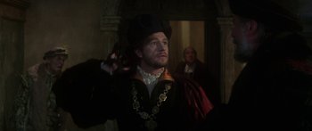 Movie still from “The Taming of The Shrew” (1967), directed by Franco Zeffirelli – A man in a black suit and a black hat; Medium shot, Over the shoulder angle