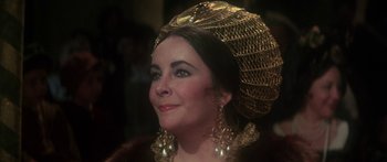 Movie still from “The Taming of The Shrew” (1967), directed by Franco Zeffirelli – A person wearing a headdress; Close Up shot, Over the shoulder angle