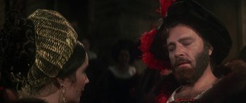 Movie still from “The Taming of The Shrew” (1967), directed by Franco Zeffirelli – A man and a woman wearing a red hat; Close Up shot, Over the shoulder angle