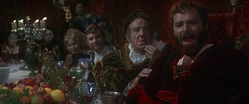 Movie still from “The Taming of The Shrew” (1967), directed by Franco Zeffirelli – A group of people sitting around a table; Medium shot, Over the shoulder angle