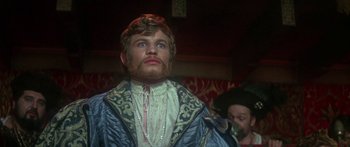 Movie still from “The Taming of The Shrew” (1967), directed by Franco Zeffirelli – A man with a long beard and a crown on; Close Up shot, Low angle