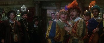 Movie still from “The Taming of The Shrew” (1967), directed by Franco Zeffirelli – A group of people dressed up in costumes; Medium shot, Over the shoulder angle