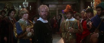 Movie still from “The Taming of The Shrew” (1967), directed by Franco Zeffirelli – Two men in renaissance garb standing next to each other; Medium shot, Over the shoulder angle