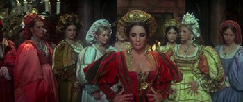 Movie still from “The Taming of The Shrew” (1967), directed by Franco Zeffirelli – A group of women dressed in renaissance costumes; Medium shot, Over the shoulder angle