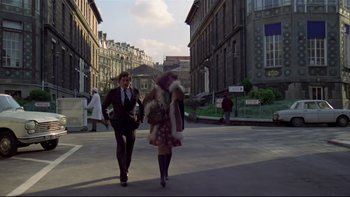 Movie still from “The Tenant” (1976), directed by Roman Polanski – A man and a woman walking down a street; Wide shot, High angle