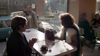 Movie still from “The Tenant” (1976), directed by Roman Polanski – Two people are sitting at a table in front of a window; Wide shot, Over the shoulder angle
