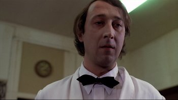 Movie still from “The Tenant” (1976), directed by Roman Polanski – A person wearing a bow tie; Close Up shot, Low angle