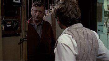 Movie still from “The Tenant” (1976), directed by Roman Polanski – A man looking at himself in the mirror; Medium shot, Over the shoulder angle