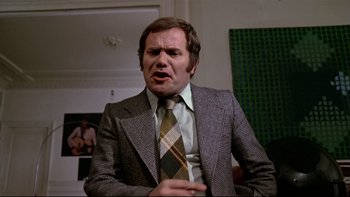 Movie still from “The Tenant” (1976), directed by Roman Polanski – An older man in a suit and a tie; Close Up shot, Low angle