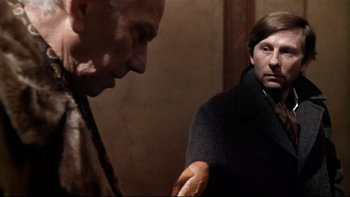 Movie still from “The Tenant” (1976), directed by Roman Polanski – A man and a woman standing next to each other in a room; Close Up shot, Over the shoulder angle