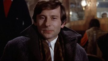 Movie still from “The Tenant” (1976), directed by Roman Polanski – A person wearing a coat and a scarf; Close Up shot, Low angle