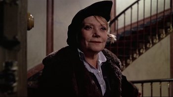Movie still from “The Tenant” (1976), directed by Roman Polanski – An older woman wearing a hat and a fur coat; Close Up shot, Low angle