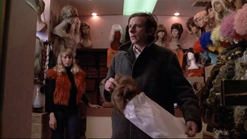 Movie still from “The Tenant” (1976), directed by Roman Polanski – A man holding a mannequin in front of other mannequins in a room; Medium shot, Over the shoulder angle