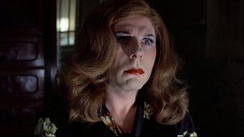 Movie still from “The Tenant” (1976), directed by Roman Polanski – A woman with red hair wearing a black shirt; Close Up shot, Low angle