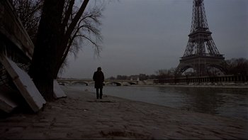 Movie still from “The Tenant” (1976), directed by Roman Polanski – A man standing on a beach near a body of water; Wide shot, Low angle