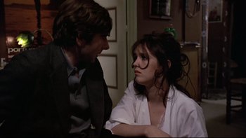 Movie still from “The Tenant” (1976), directed by Roman Polanski – A man and a woman sitting next to each other in a room; Close Up shot, Over the shoulder angle