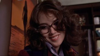 Movie still from “The Tenant” (1976), directed by Roman Polanski – A person wearing glasses and smiling; Close Up shot, Low angle