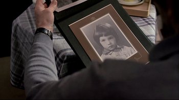 Movie still from “The Tenant” (1976), directed by Roman Polanski – A person holding a picture of a young girl; Extreme Close Up shot, High angle