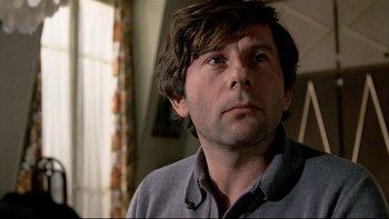 Movie still from “The Tenant” (1976), directed by Roman Polanski – A person looking at the camera; Close Up shot, Low angle